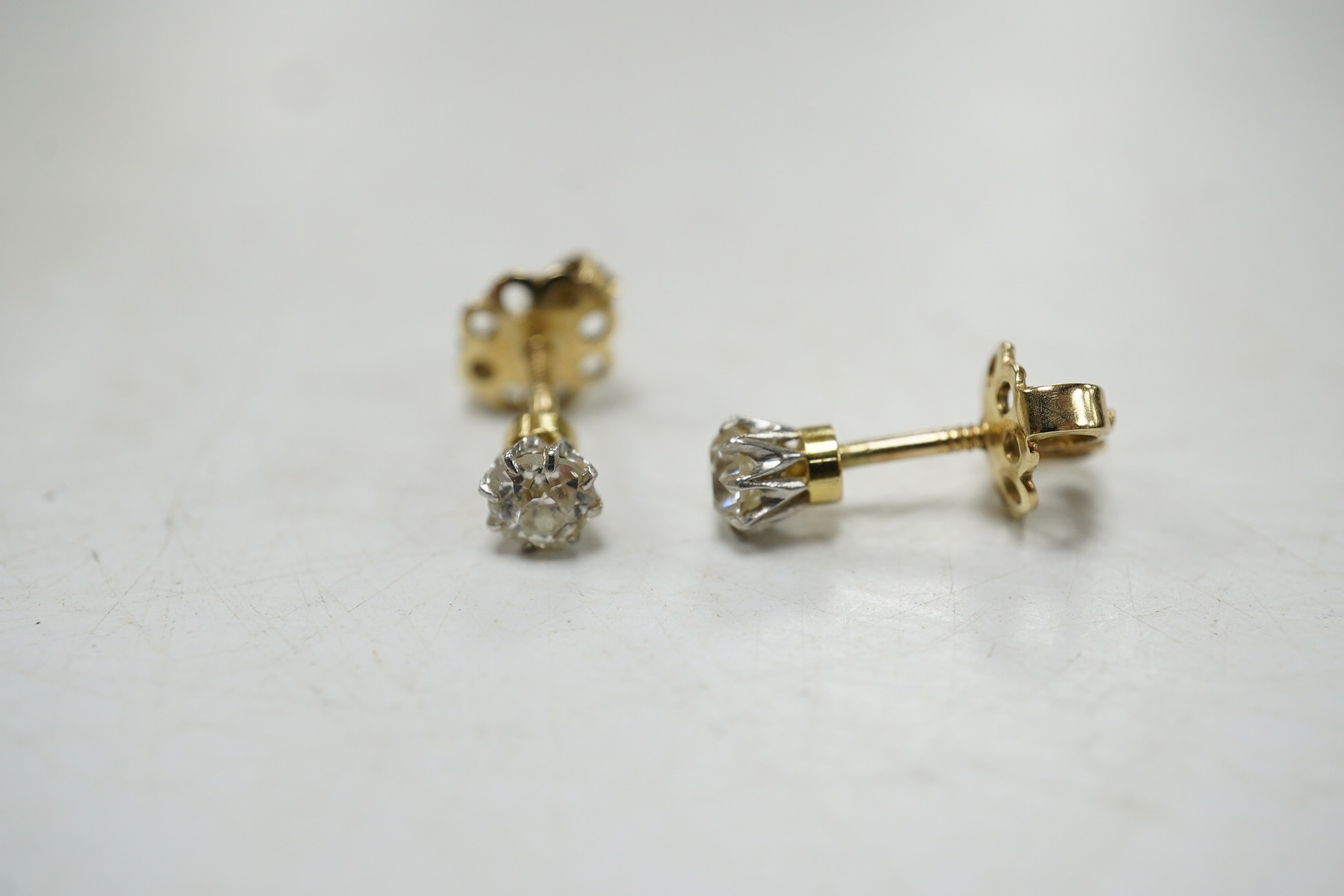 A pair of yellow metal and solitaire diamond set ear studs, gross weight 1 gram. Condition - fair to good